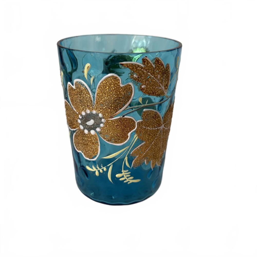 Antique blue glass tumbler with hand-painted gold floral designs.